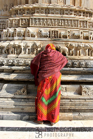 Standing Woman In Orange Striped Sari Praying