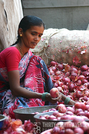 Lovely Lady In Red Sari Selling Red Onions At Market