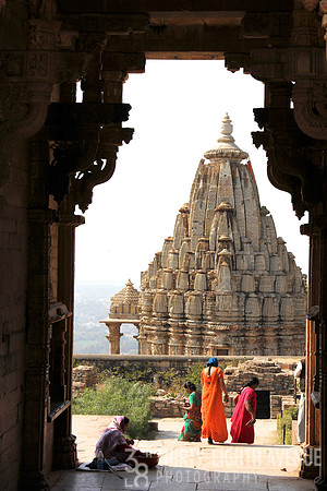 A View Of Women In Orange & Pink Saris At Stupa
