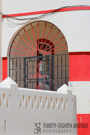 Arched Door with Red Iron Sun & Boat