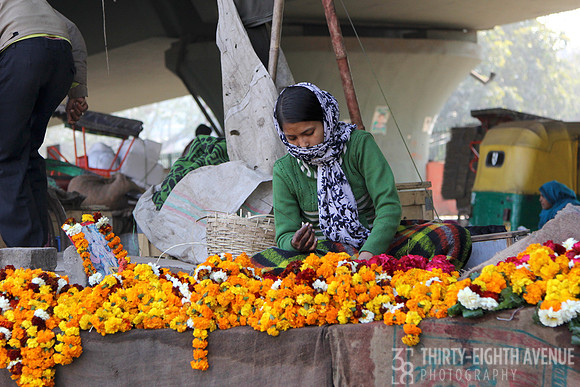 Woman Making & Selling Fresh Marigold Flower Necklaces