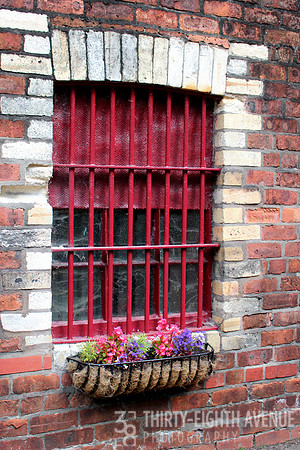 Distillery Red Grated Window With Flower Box