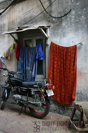 Motocycle & Hanging Laundry In Alley