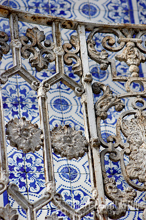 White Iron Balcony In Front Of  Blue & White Tile